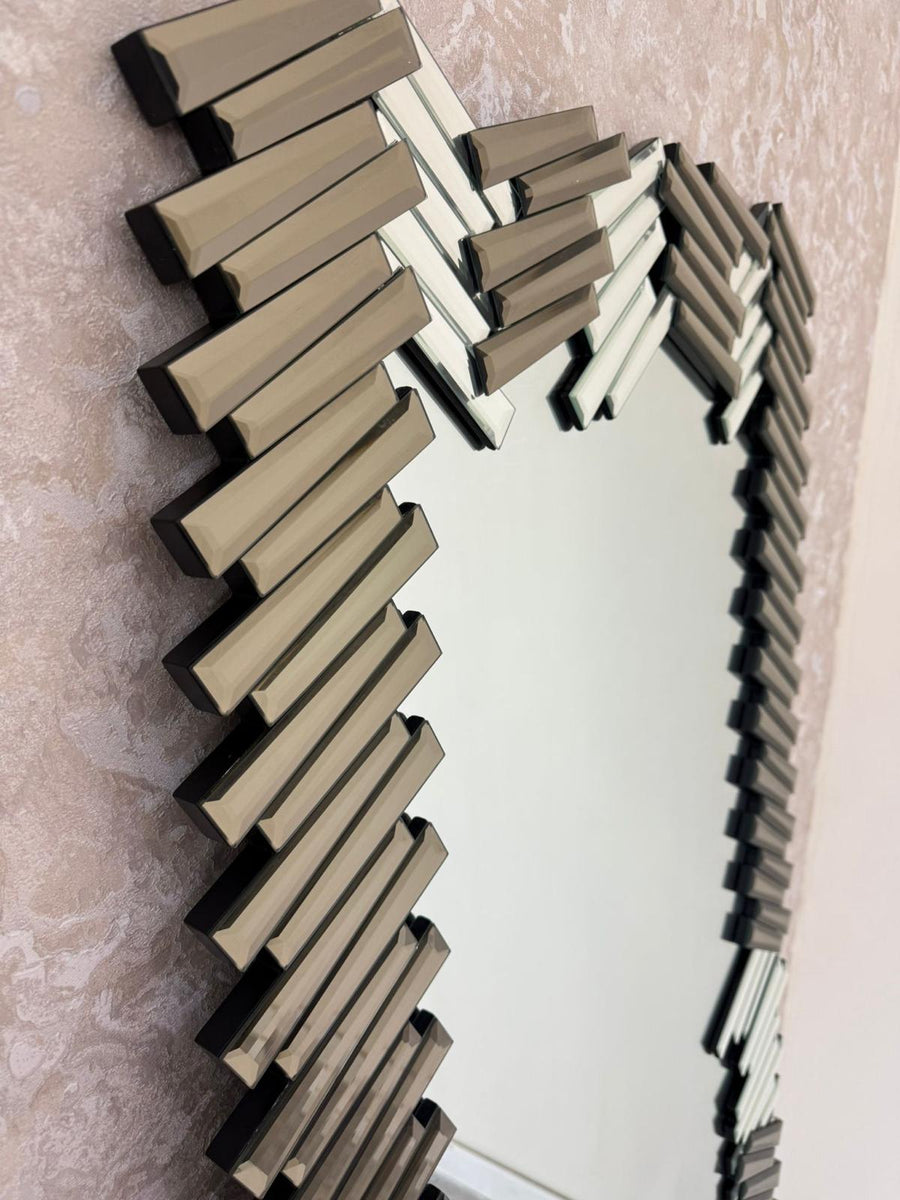 Decorative mirror with zigzag pattern on a textured wall