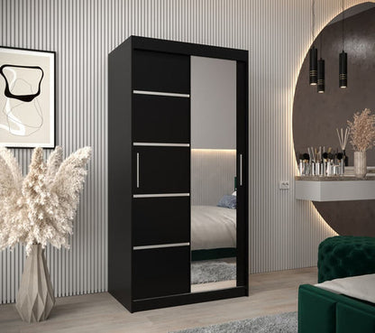 Black wardrobe with mirror in a bedroom setting
