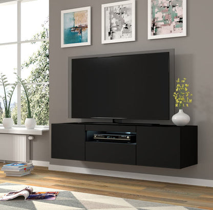 Modern living room with black TV stand, flat-screen TV, and decorative elements.