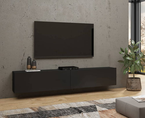 Modern living room with a black TV stand, television, and decorative items.