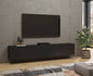 Modern living room with a black TV stand, television, and decorative items.