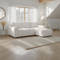 White sectional sofa in a bright living room with large windows.