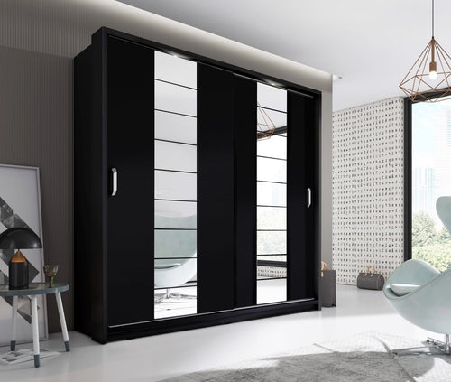 Modern black wardrobe with sliding doors in a stylish room.