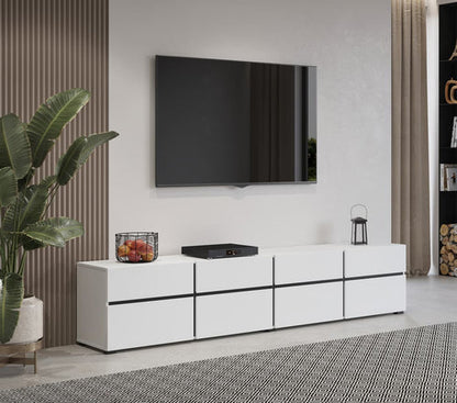 Modern living room with a white entertainment console, TV, and decorative items.
