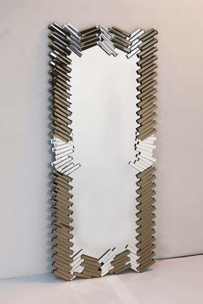 Decorative wall mirror with zigzag pattern on a white background