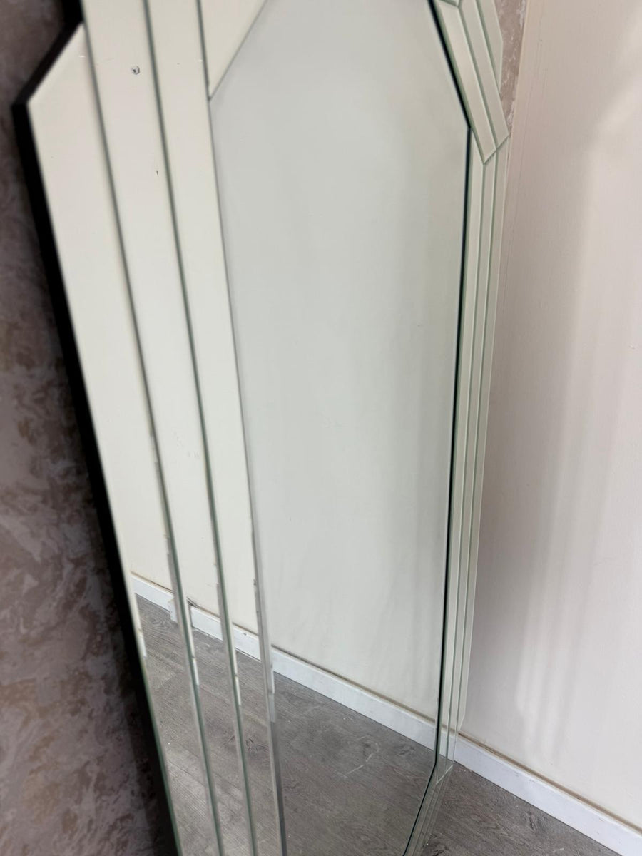 Glass shower enclosure with a white frame on a tiled floor.