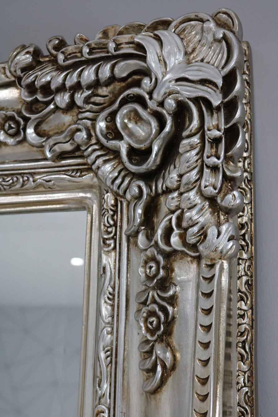 Decorative silver mirror with intricate floral patterns