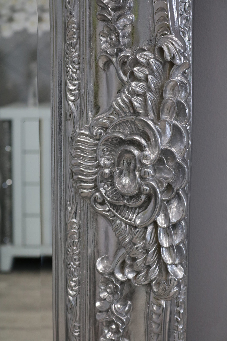 Decorative silver mirror with intricate floral patterns