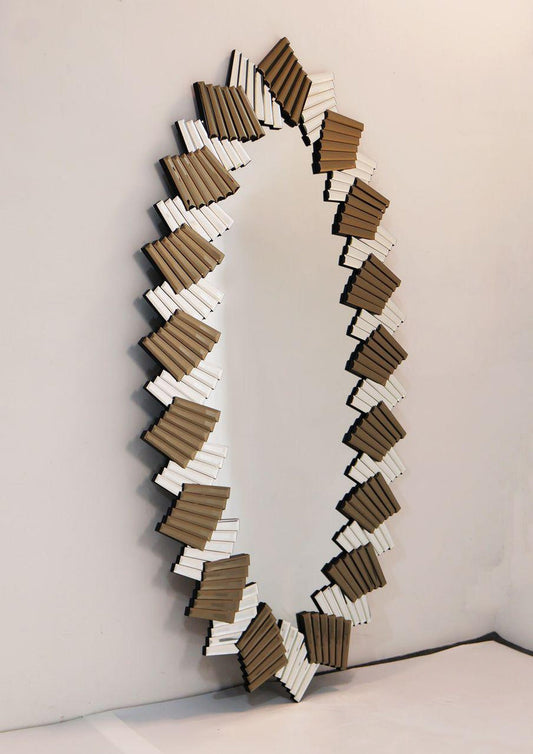 Decorative mirror with wavy, layered design on a plain background