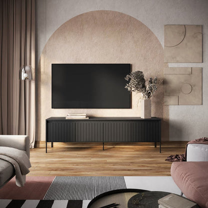 Modern living room with a television on a black stand, decorative wall art, and a gray sofa.