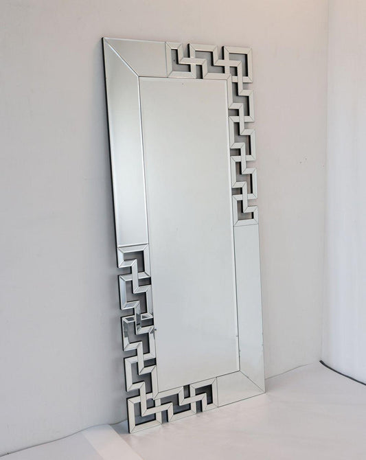 Decorative mirror with geometric frame on a white background