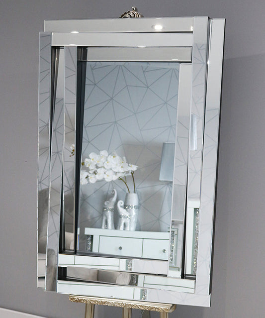 Decorative mirror with geometric design on a gray wall