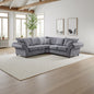 Gray sectional sofa in a bright living room with large windows and wooden beams.