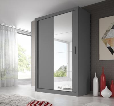Gray sliding door wardrobe with mirror in a room with a window and decorative vases.