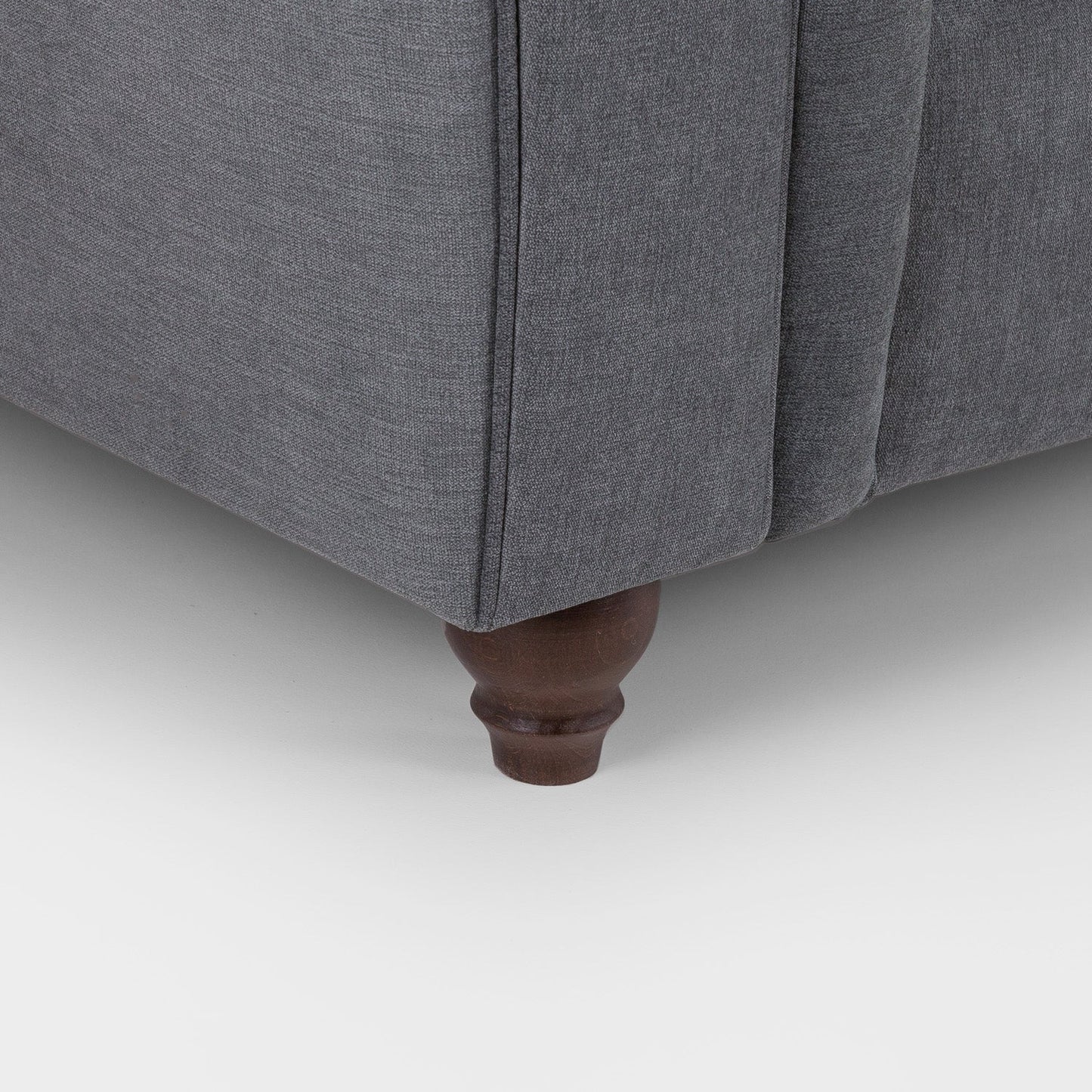 Gray upholstered furniture with wooden leg on a white background