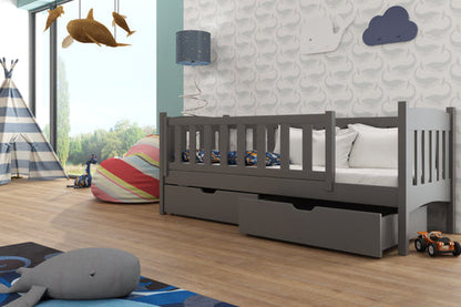 Children's bedroom with a gray bed, toys, and colorful decor.