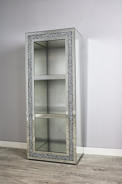 Decorative cabinet with crystal embellishments on a plain wall.