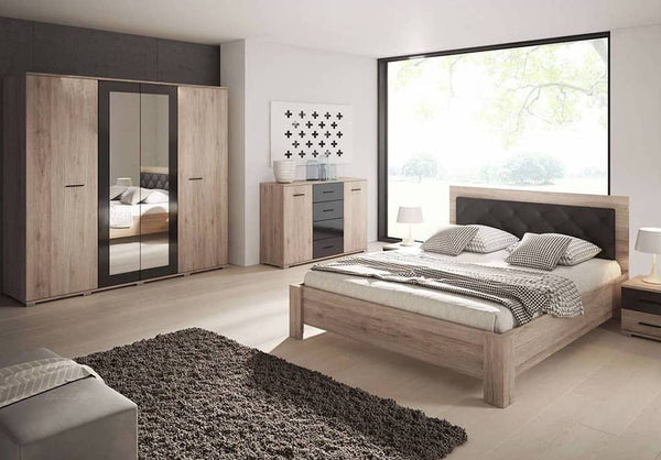 Modern bedroom with wooden furniture including a bed, wardrobe, and dresser.
