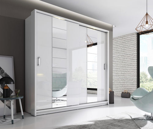 Modern white wardrobe with sliding doors in a stylish room.